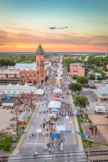 Aerial view of Grapevine Historic Main Street filled with festival tents at sunset