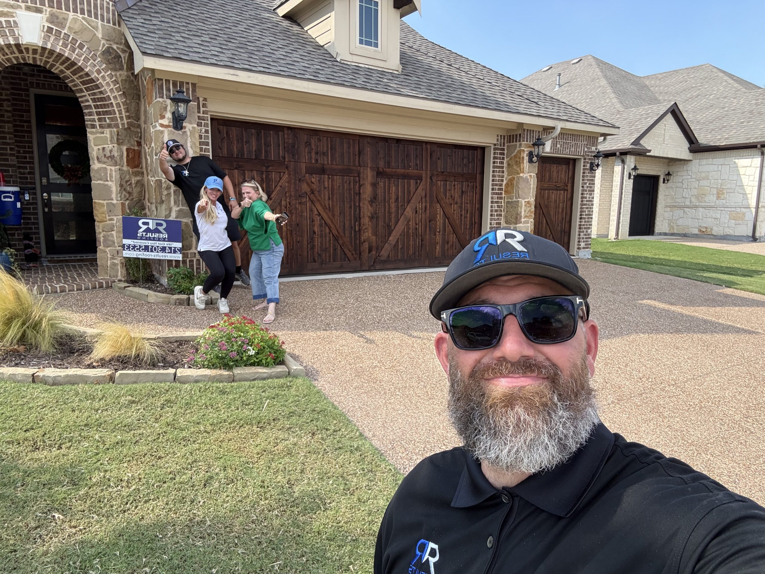 Jennifer celebrating the completed project in the driveway with the Results Roofing team